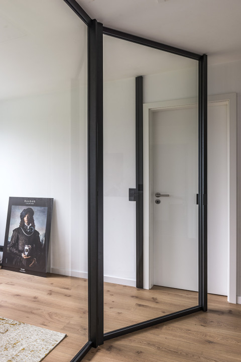 Separation between office and hall without loss of light and openness thanks to ARLU's divina - a glass divider with glass swing door