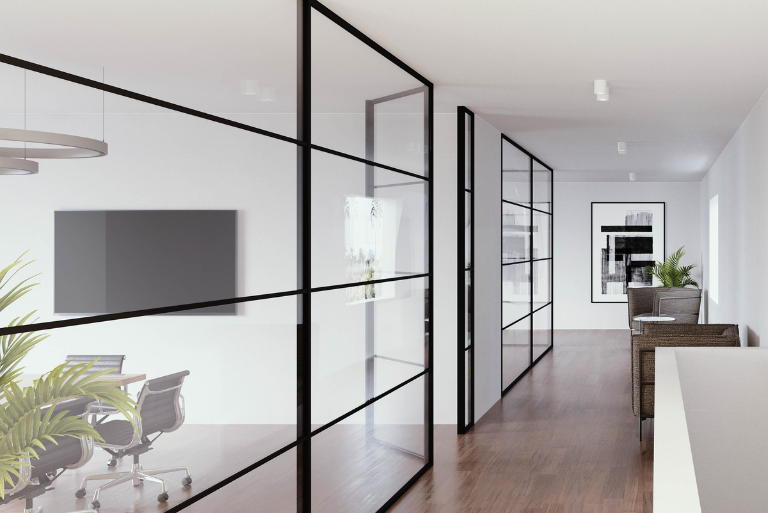 Divina zwarte room divider met draaideur. De draaideur is ingewerkt in de vaste wand met onzichtbare scharnieren.